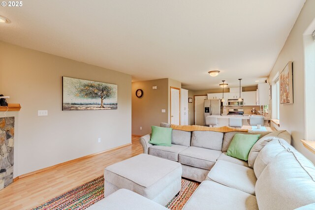 595 Cozy Way, Woodburn, OR 97071 - living room with light wood-type flooring and a fireplace