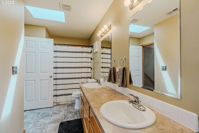 595 Cozy Way, Woodburn, OR 97071 - bathroom featuring a skylight and double vanity