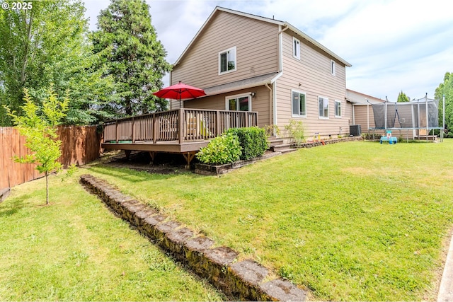 595 Cozy Way, Woodburn, OR 97071 - rear view of property with a trampoline and a wooden deck