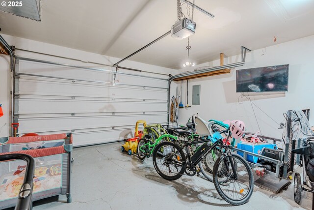 595 Cozy Way, Woodburn, OR 97071 - garage featuring a garage door opener and electric panel