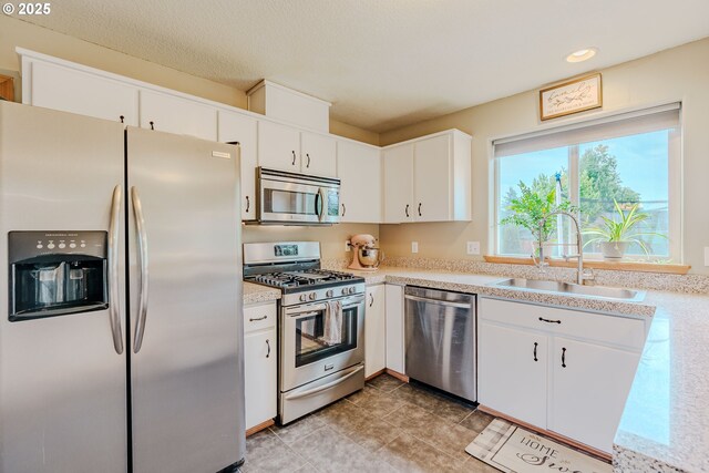 595 Cozy Way, Woodburn, OR 97071 - kitchen with stainless steel appliances, light countertops, white cabinets, and recessed lighting