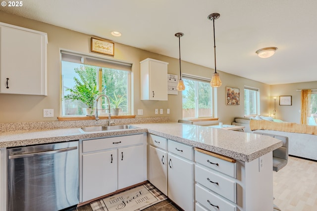 595 Cozy Way, Woodburn, OR 97071 - kitchen with dishwasher, a peninsula, open floor plan, light countertops, and white cabinets