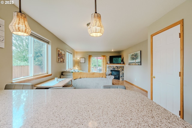 595 Cozy Way, Woodburn, OR 97071 - kitchen featuring a stone fireplace and hanging light fixtures