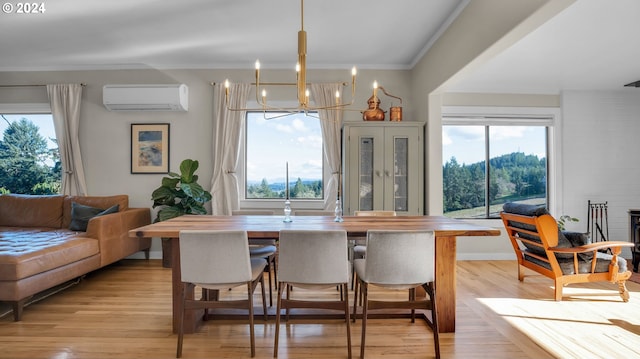 dining space with a wall mounted AC, a chandelier, healthy amount of natural light, light wood finished floors, and ornamental molding