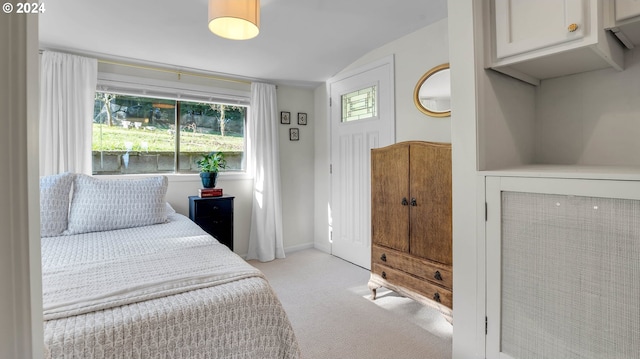 bedroom with carpet and vaulted ceiling