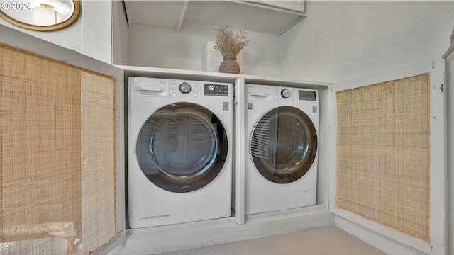 clothes washing area with washing machine and clothes dryer