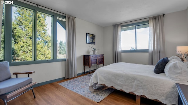 bedroom featuring wood finished floors and baseboards