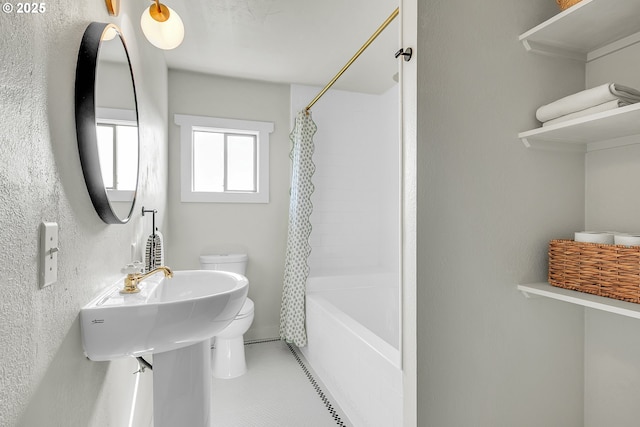 bathroom featuring toilet and shower / bath combination with curtain