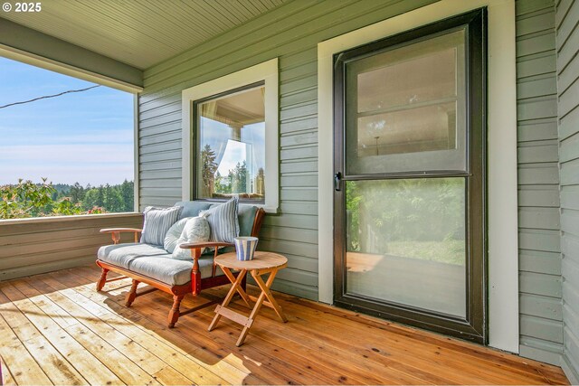 sunroom with wood walls and hardwood / wood-style floors