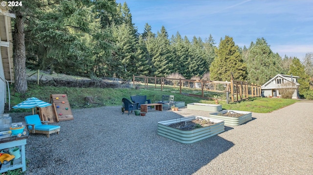 view of property's community featuring fence and a vegetable garden