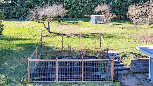 view of grassy yard with a garden