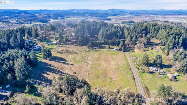 aerial view of property and surrounding area featuring a mountainous background