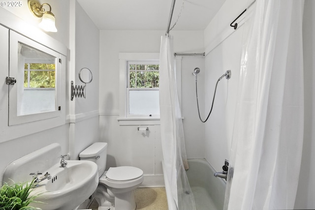 full bathroom with a sink, toilet, and shower / bathtub combination with curtain