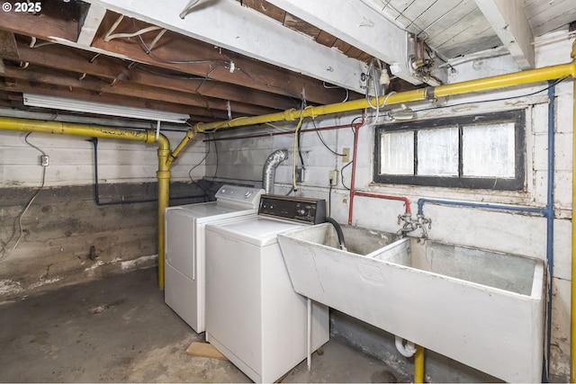 washroom featuring laundry area, a sink, and washer and dryer