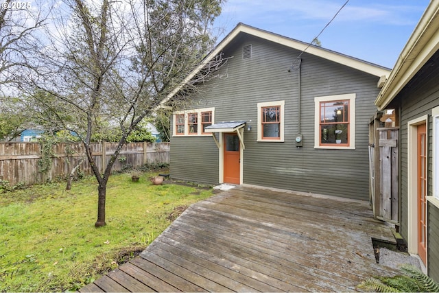 deck with a yard and fence