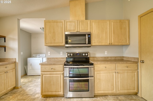 kitchen featuring washer and clothes dryer, light brown cabinets, and stainless steel appliances