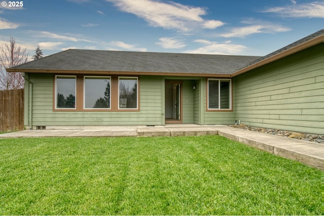 view of front of house with a patio area, a front lawn, and fence