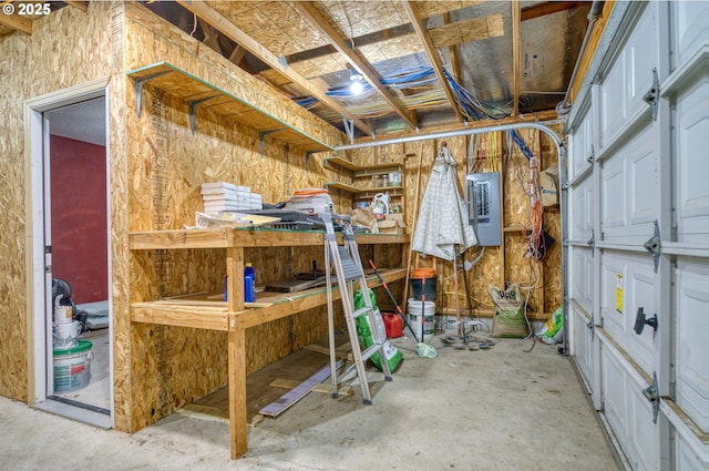 storage area featuring electric panel and a garage