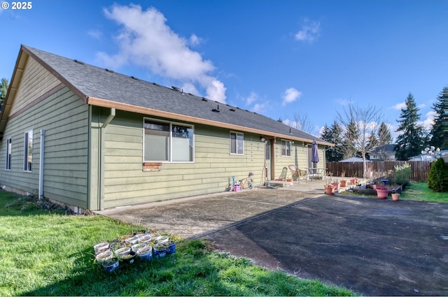 back of house with a lawn, a patio, and fence