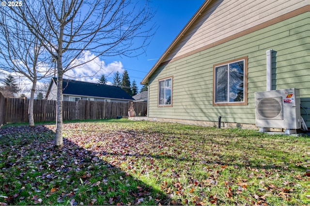 view of yard featuring ac unit and fence