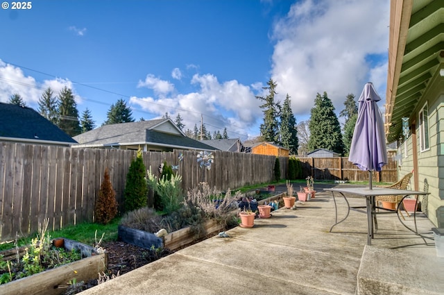 view of patio / terrace with a garden and a fenced backyard