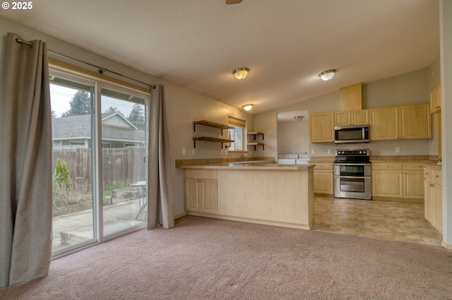 kitchen featuring light carpet, appliances with stainless steel finishes, light brown cabinetry, and light countertops