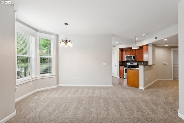 kitchen with light colored carpet, backsplash, appliances with stainless steel finishes, brown cabinetry, and open floor plan