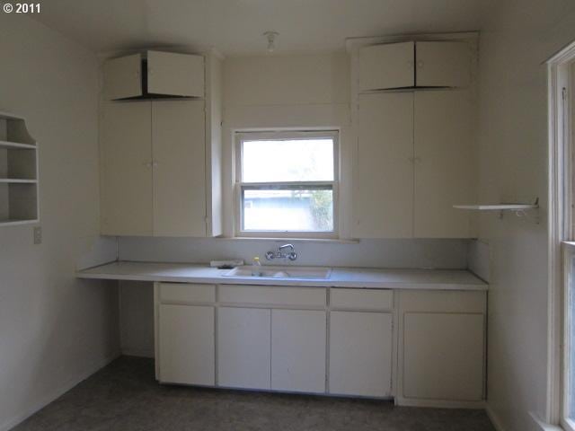 1725 SE Mill St, Roseburg, OR 97470 - kitchen featuring white cabinetry, light countertops, and a sink