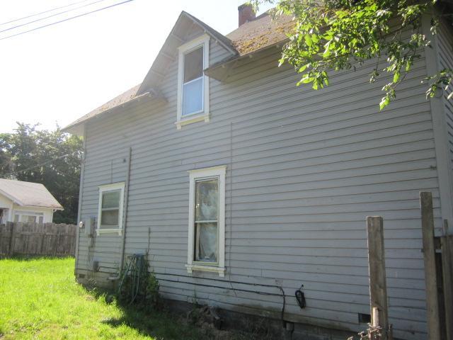 1725 SE Mill St, Roseburg, OR 97470 - view of property exterior featuring a yard, fence, and a chimney