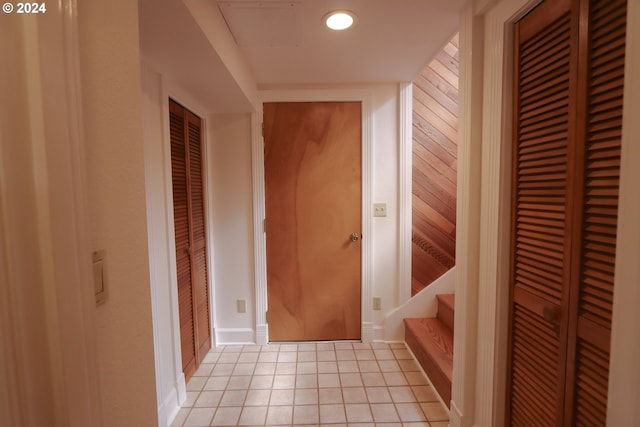 hall with light tile patterned floors