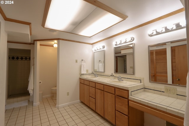 bathroom featuring tile patterned flooring, vanity, toilet, and ornamental molding