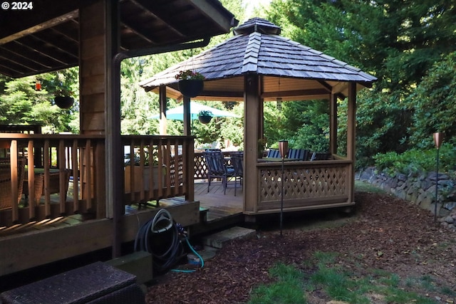 wooden terrace featuring a gazebo