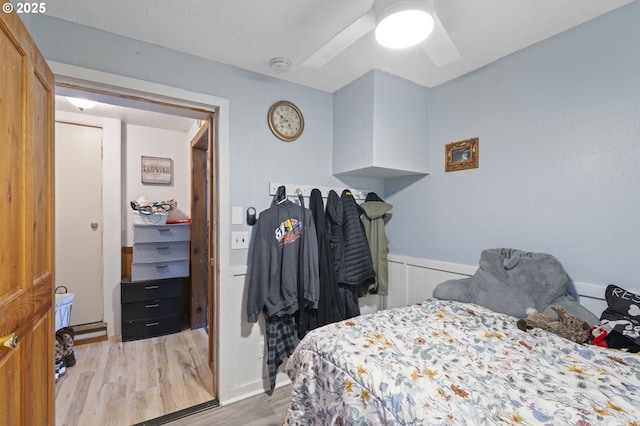 1135 Birch Ave, Cottage Grove, OR 97424 - bedroom with light wood-style flooring, ceiling fan, and a wainscoted wall