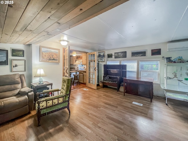 34360 NE Colorado Lake Dr Unit 996, Corvallis, OR 97333 - living area featuring a wall mounted air conditioner, wood finished floors, and french doors