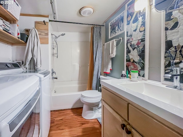 34360 NE Colorado Lake Dr Unit 996, Corvallis, OR 97333 - bathroom with washing machine and dryer, vanity, toilet, wood finished floors, and shower / bath combo