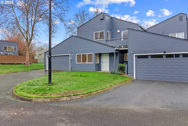 view of front of home featuring a front yard and a garage