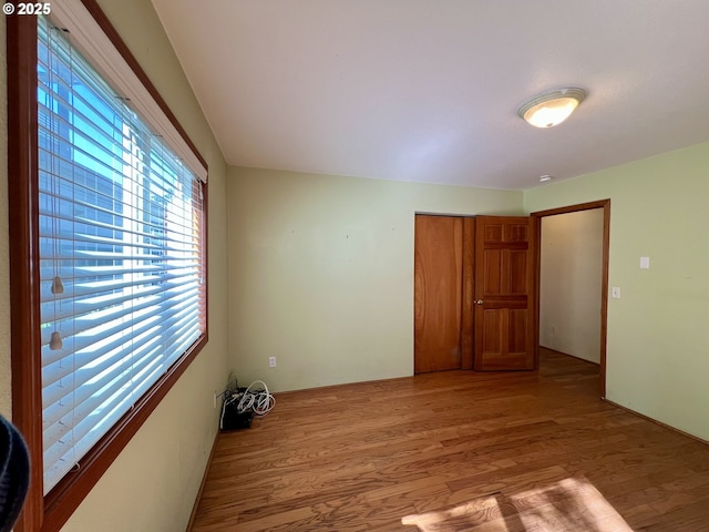 3715 Coho Pl, Cannon Beach, OR 97110 - unfurnished bedroom featuring multiple windows, light wood-type flooring, and a closet