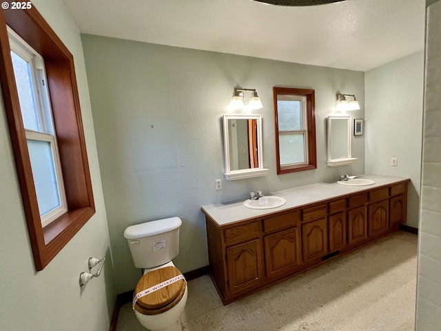 3715 Coho Pl, Cannon Beach, OR 97110 - bathroom featuring toilet, plenty of natural light, double vanity, and baseboards
