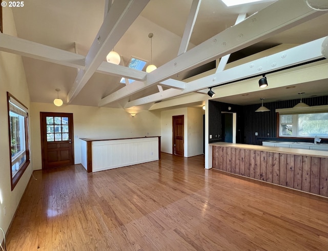 3715 Coho Pl, Cannon Beach, OR 97110 - unfurnished living room with high vaulted ceiling, wood finished floors, and beam ceiling