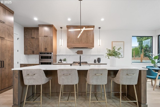 kitchen featuring recessed lighting, light wood-style flooring, appliances with stainless steel finishes, a large island, and modern cabinets