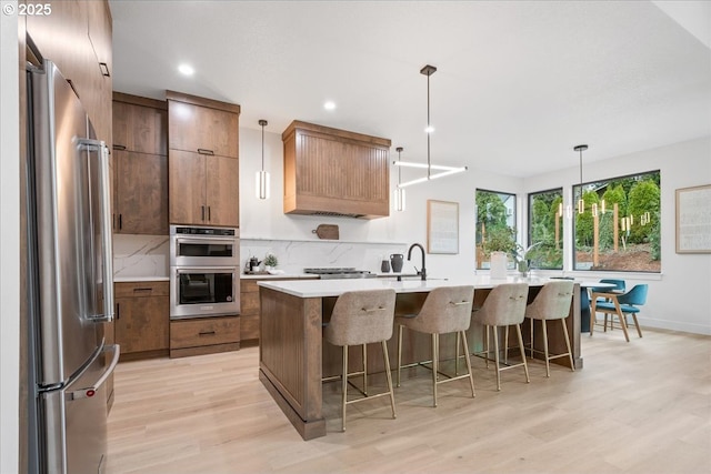 kitchen with decorative backsplash, appliances with stainless steel finishes, and light countertops