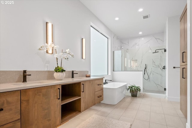 bathroom featuring a sink, recessed lighting, a marble finish shower, double vanity, and a freestanding bath