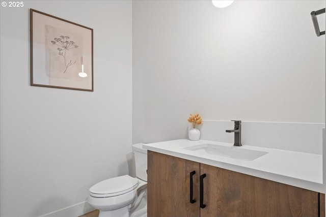 bathroom with toilet and vanity
