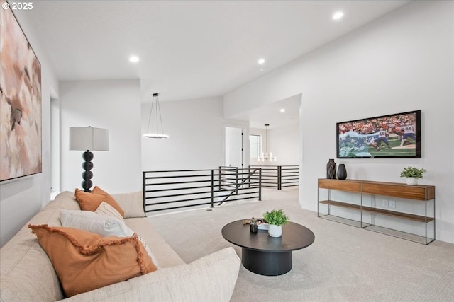 living area featuring vaulted ceiling, carpet flooring, recessed lighting, and a chandelier