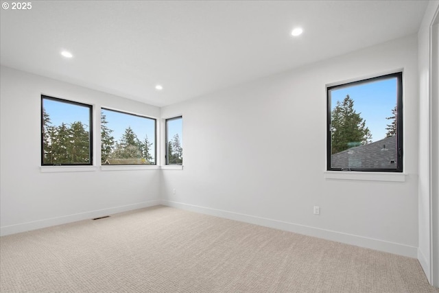 spare room with recessed lighting, baseboards, and carpet