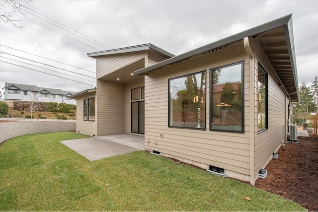 back of property featuring a patio and a yard