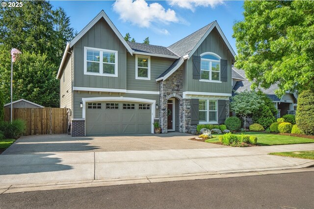 21163 SW Nursery Way, Sherwood, OR 97140 - view of front of home featuring board and batten siding, concrete driveway, an attached garage, and stone siding