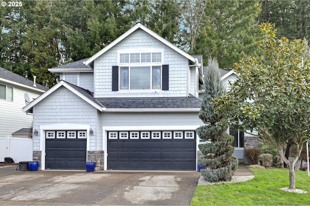 1044 N 26th Ter, Cornelius, OR 97113 - view of front of home with roof with shingles, concrete driveway, stone siding, and a garage