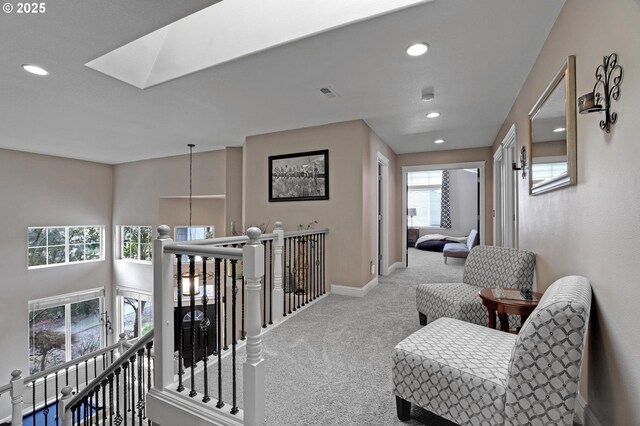 1044 N 26th Ter, Cornelius, OR 97113 - corridor with carpet flooring, an upstairs landing, a skylight, recessed lighting, and baseboards