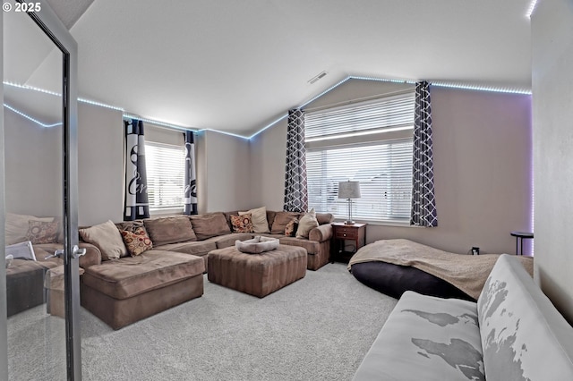 carpeted living room with lofted ceiling